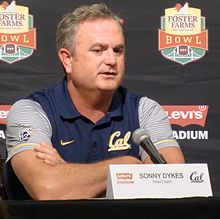 Sonny Dykes in a vest at a press conference.