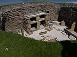 A dresser with shelves furnishes a house in Skara Brae, a settlement in what is now Scotland that was occupied from about 3180–2500 BC