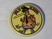 Promotional button for Kiwi International Airlines, circa 1994. Diameter 54mm. Yellow background, with cartoon figure of a Kiwi bird wearing airline captain's hat, tie, wings, and shoulder insignia. Says "FLY WIKI" in red block letters on the top, and "Kaptain Kiwi" in script across the bottom.