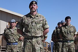 A Royal Navy officer wearing Multi-Terrain Pattern (MTP) as No. 5 dress, with a beret. This can include a stable belt.