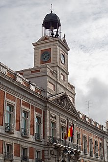 Photograph of a large, early-modern building with a prominent clocktower.