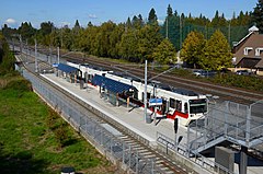 A MAX train stopped at Southeast Bybee Boulevard station seen from above on the Bybee Bridge