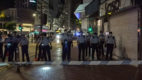 Tactical unit police officers conducting a carpet search near the scene of the attack at midnight