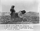 Armenian woman kneeling beside dead child in field "within sight of help and safety at Aleppo"