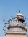 The mosque's dome is decorated with tile work.