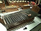 Kolintang, a traditional xylophone-like instrument from Sulawesi, consisting of wooden bars of varying lengths that are struck with mallets to produce melodic and harmonious sounds.