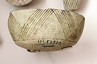 Fragment of pottery with incised and painted decor. From Tell Hassuna, 6500 - 6000 BC.