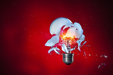 High-speed photography of a light bulb shot with an airsoft pistol (positioned right of the lamp).