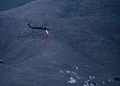 A UH-60 Black Hawk providing close air support using its side-mounted M134 Minigun turrets