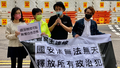 Jimmy Sham (second from right), the former convener of the Civil Human Rights Front, and Helena Wong, a former legislator of the Democratic Party, report to the Yau Ma Tei Police Station