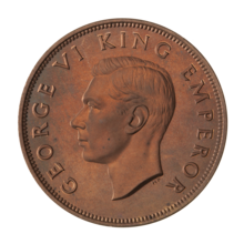 A proof penny featuring the head of King George VI circled by the text "GEORGE VI KING EMPEROR"