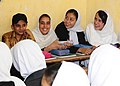 2010 - A classroom of Afghan students share a laugh during a visit from Afghan National Civil Order Police and Coalition Forces.