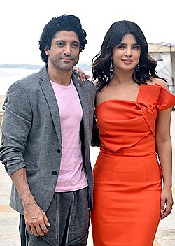 A photograph of Farhan Akhtar and Priyanka Chopra Jonas looking forward, smiling and posing for the camera