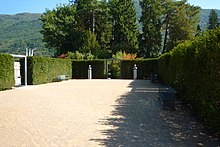 Open outdoor space, surrounded by a hedge