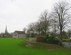 Site of the Chichester gaol, this modern photograph, shows the remains of the motte in Priory Park, that was once home to the castle keep. It is all that remains of a defensive motte and bailey built by the Normans in the 11th century. Behind the mound is the former guildhall. After the dissolution the land was given over to the Duke of Richmond whose descendants finally passed it over to the city who in turn made it a public park.