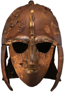 Studded and decorated metallic mask of human face.