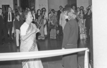 Photo of two women facing each other in front of a crowd