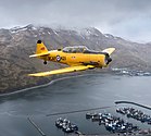 Eine Harvard Mark IV in den Farben der RCAF überfliegt am 3. Juni 2017 zum 75. Jahrestag der Schlacht um die Aleuten Dutch Harbor auf Unalaska KW 39 (ab 23. September 2018)