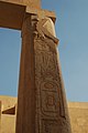 Tall stone column inscribed with hieroglyphs from top to bottom