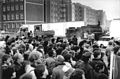 A large crowd looking at road construction work in preparation for the border crossing between West Berlin (front of picture) and East Berlin (behind the wall) on 11 November 1989.