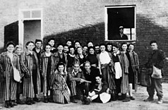 Another photo of camp inmates with the liberators, notably showing female prisoners, who were moved to the camp in the final days of its existence