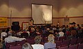 An Oregon arborist providing a slideshow presentation about tree care and pruning at a garden show in Portland, Oregon