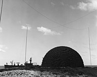 Shot Charlie, ready for detonation. USS Atlanta is moored in the background, with her bow facing left