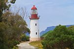 The Robben Island Lighthouse, located on Robben Island in Table Bay, South Africa, is a historically significant maritime beacon. Constructed in 1865, the lighthouse stands as a crucial navigational aid, guiding ships safely through the treacherous waters surrounding the island. It is situated at the highest point of the island, Minto Hill, and is easily recognizable by its distinctive white and red bands.