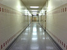 An example of a liminal space. This is an image of a long, empty hallway.