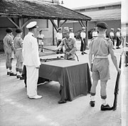 Fransız Çinhindi Saigon'da bir Japon gedikli subayı, düzenlenen bir törenle kılıcını bir İngiliz asteğmeni Anthony Martin'e teslim ediyor.