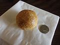 A tambun biscuit, with coin for scale