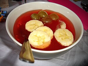 Kissel served with bananas and grapes
