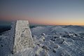 The base of a survey trig marker at the summit