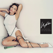 A woman is posing while wearing a white dress and high heels. A wired microphone is wrapped up on her left leg. A black box featuring the words 'Kylie' and 'Can't Get You Out of My Head' in white is placed on the right.