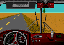 A video game screenshot resembling the first-person view of a bus driver. It features vehicle controls across the bottom, including a steering wheel, fuel gauge, and speedometer on the left, an odometer in the center, and a digital clock on the right. Hanging from the top are a sun visor bearing the player-entered name of the driver and a rearview mirror depicting rows of empty seats in the back of the bus. A tree-shaped air freshener is dangling from that mirror. Outside the front window is a straight, empty, two-lane road with sandbanks on both sides. The bus is in the right lane and driving towards the right-hand sandbank.