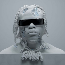 Light grey bust of Gunna wearing dark and wide sunglasses as well as a chain that reads his stage name. In some sections, the sculpture is cracking to reveal the ice-like crystals sitting underneath