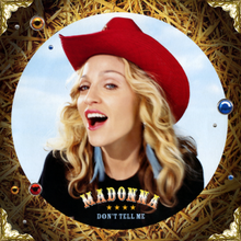 Madonna smiling towards the camera, wearing a cowboy hat.