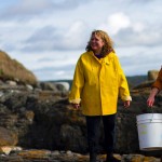 Three people on beach with buckets