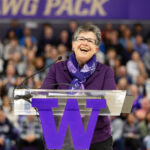 woman at podium with purple W