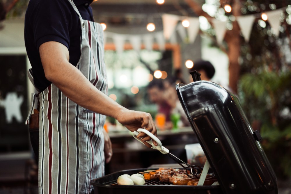 Asian man are cooking for a group of friends to eat barbecue