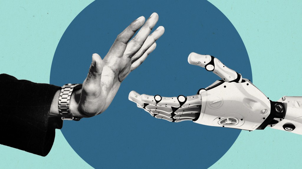 A human hand turning down a handshake from a robot hand