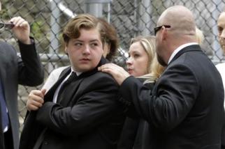 Michael Gandolfini, left, James Gandolfini's teen son, arrives at today's funeral service.