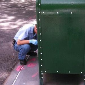 A postal workers repainting a mailbox in Brooklyn Heights after our hero repainted over graffiti.