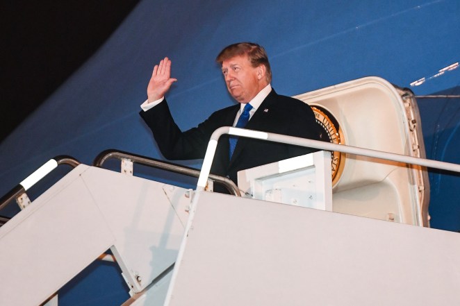President Donald Trump waves after he arrives in Vietnam ahead of his second summit with North Korean leader Kim Jong Un.