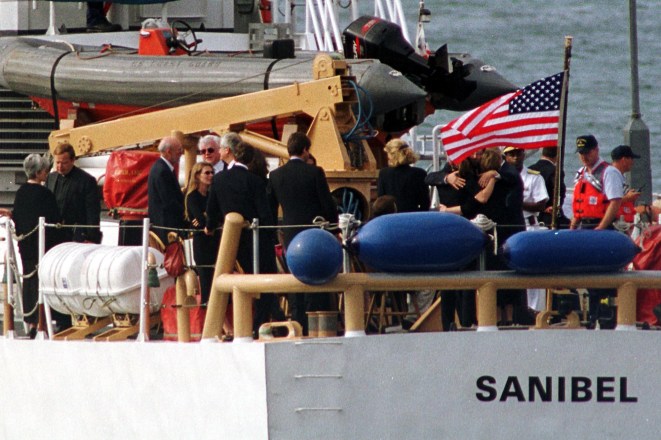 Members of the Kennedy and Bessette families gather at the stern of the Coast Guard ship Sanibel.