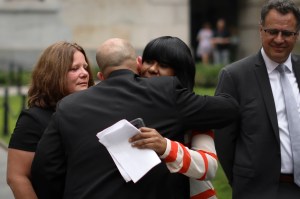 Auset Love hugs her attorney after she filed a lawsuit alleging she was abused by a teacher starting at the age of 9.