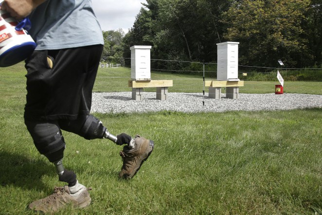 US Army veteran Oscar Toce cleans up after beekeeping.