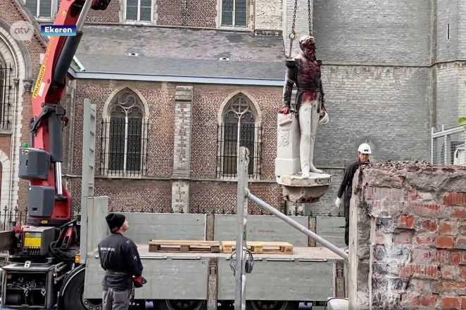 A damaged statue of former Belgian King Leopold II is seen being removed for possible renovation in Ekeren, Belgium.