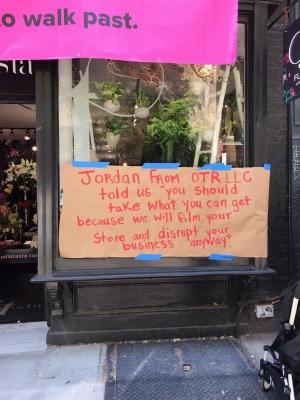 Signs outside the Julia Testa Flower store on Monday.