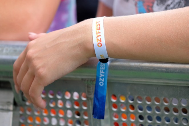 a person wears an OZY Fest wristband 